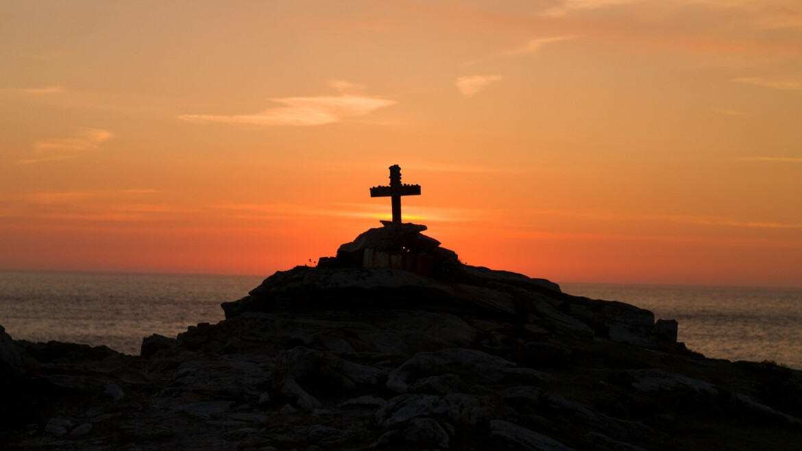 A Cross perched on the Cliffs of Malin Head, Co. Donegal, Ireland. A Memorial to a young french man who drowned off the coast. Nowadays visitors leave coins and other religious items on the monument.