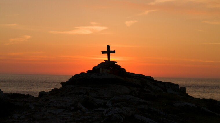 A Cross perched on the Cliffs of Malin Head, Co. Donegal, Ireland. A Memorial to a young french man who drowned off the coast. Nowadays visitors leave coins and other religious items on the monument.
