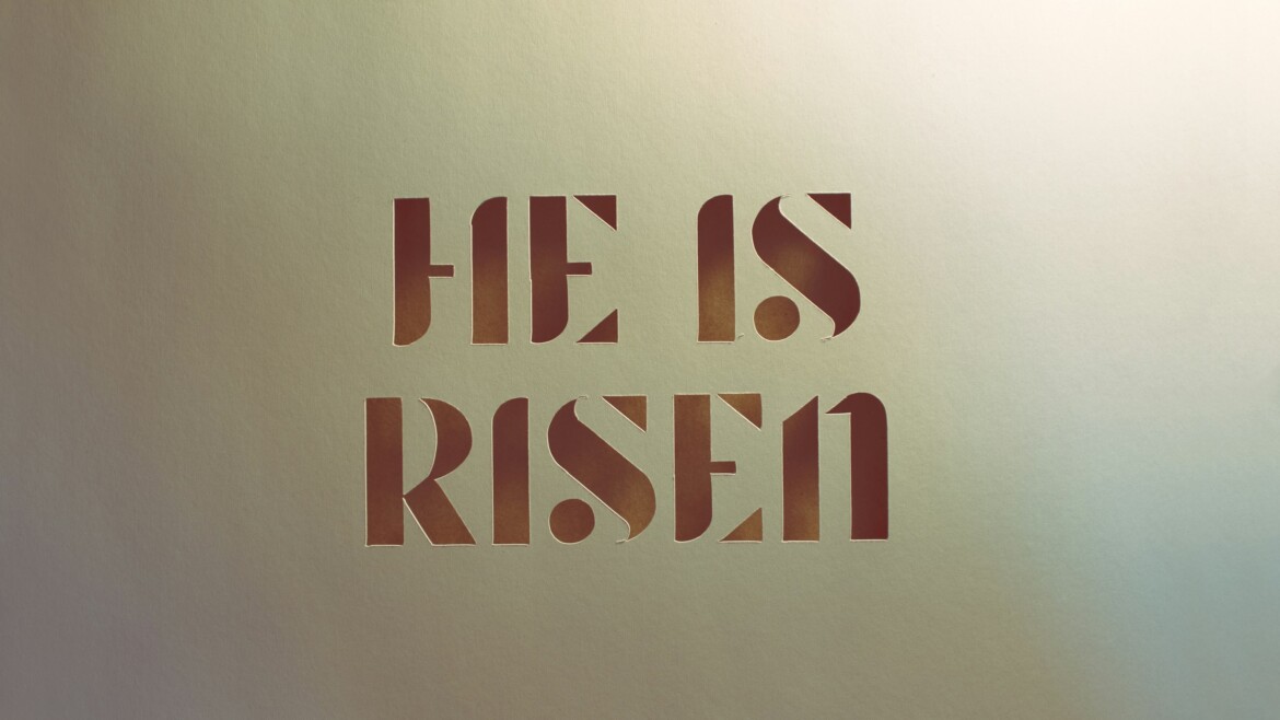 He is risen paper cut words against kraft brown paper